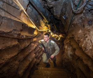 An Israeli soldier stands at a Hezbollah tunnel that crosses from Lebanon to Israel. (Basel Awidat/Flash90)