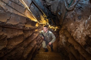 An Israeli soldier stands at a Hezbollah tunnel that crosses from Lebanon to Israel. (Basel Awidat/Flash90)