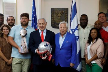 Benjamin Netanyahu with Patriots owner Robert Kraft and several players. (AP Photo/Sebastian Scheiner)