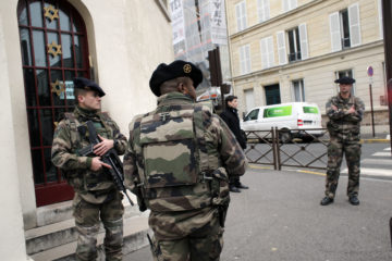 Soldiers stand guard outside a synagogue in Paris, France. (AP Photo/Christophe Ena)