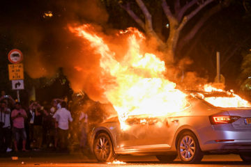 A car on fire during a protest in Tel Aviv following the death of 19-year-old Ethiopian, Solomon Tekah, who was shot and killed a few days ago by an off-duty police officer, July 2, 2019. (Flash90)