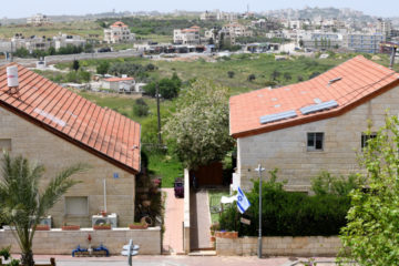 The Jewish community of Beit El in Judea and Samaria, backdropped by the neighboring Palestinian refugee camp Jalazone.