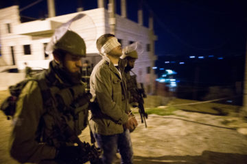Israeli soldiers arrest a Palestinian. (illustrative) (Nati Shohat/Flash90)