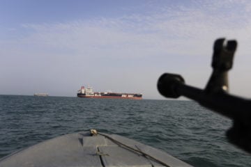 A speedboat of Iran's Revolutionary Guard trains a weapon toward the British-flagged oil tanker Stena Impero, which was seized in the Strait of Hormuz.