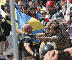 White nationalist demonstrators clash with counter demonstrators at the entrance to Lee Park in Charlottesville, Va., on Aug. 12, 2017.