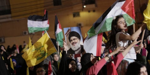 Supporters of Hezbollah leader Hassan Nasrallah wave Palestinian flags during a rally in a southern suburb of Beirut, Lebanon, Friday, May 31, 2019.