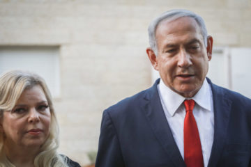 Prime Minister Benjamin Netayahu and his wife Sara speak with the media outside the Sorek family home, in Ofra on August 13, 2019.