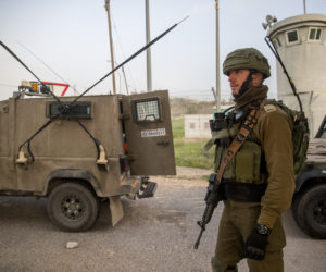 Israeli soldiers guard at a checkpoint on Highway 443.