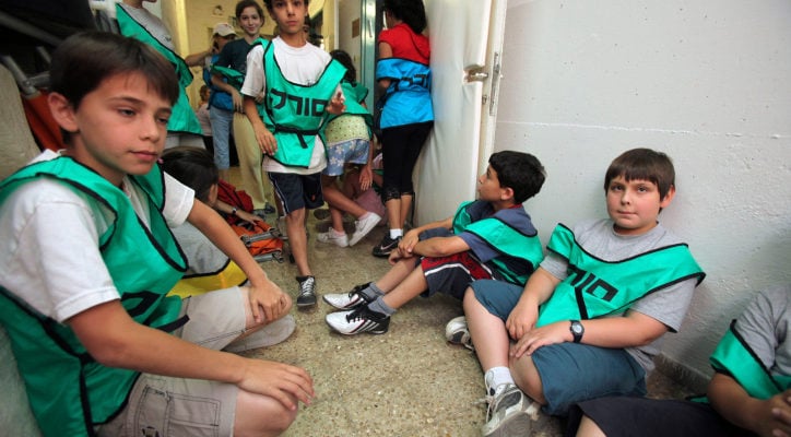Israeli children return to school with dancing, singing, but in north a new, tense reality