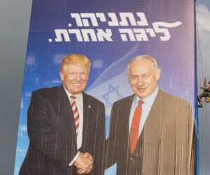A worker hangs an election campaign billboard of the Likud party showing Israeli Prime Minister Benjamin Netanyahu, right, and US President Donald Trump in Bnei Brak, Israel, Sunday, Sept 8, 2019.