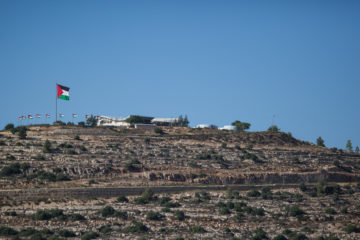 View of the Palestinian flag in the Palestinian city of Rawabi as seen from the the Jewish community of Ateret in Samaria