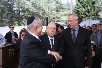 President Reuven Rivlin, Prime Minister Benjamin Netanyahu, and Blue and White leader Benny Gantz, shake hands at the memorial ceremony for the late President Shimon Peres, at the Mount Herzl cemetery in Jerusalem, on September 19, 2019.