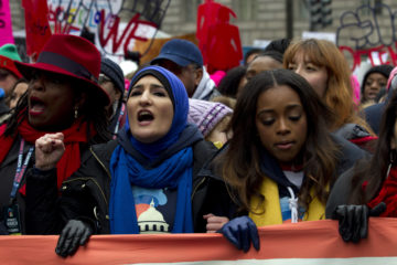 Co-presidents of the 2019 Women's March Linda Sarsour, center, and Tamika Mallory, right, march along with other demonstrators on Pennsylvania Av. during the Women's March in Washington on Saturday, Jan. 19, 2019.
