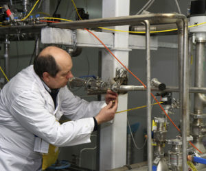 An International Atomic Energy Agency (IAEA) inspector cuts the connections between the twin cascades for 20 percent uranium enrichment at the Natanz facility, some 200 miles (322 kilometers) south of the capital Tehran, Iran, Monday, Jan. 20, 2014.