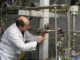 An International Atomic Energy Agency (IAEA) inspector cuts the connections between the twin cascades for 20 percent uranium enrichment at the Natanz facility, some 200 miles (322 kilometers) south of the capital Tehran, Iran, Monday, Jan. 20, 2014.