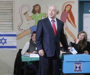 Israeli Likud party leader Benjamin Netanyahu casts his ballot at a polling station