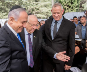President Reuven Rivlin, center, showing the way to Prime Minister Benjamin Netanyahu, left, and Blue and White leader Benny Gantz, at a memorial ceremony for the late President Shimon Peres in Jerusalem, on September 19, 2019.