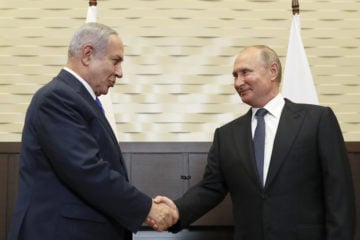 In this Sept. 12, 2019 file photo, Russian President Vladimir Putin, right, shakes hands with Israeli Prime Minister Benjamin Netanyahu during their meeting in Sochi, Russia.