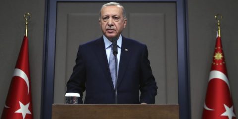 Turkish President Recep Tayyip Erdogan talks to reporters before traveling to Russia to meet with Russian President Vladimir Putin, in Ankara, Tuesday, Oct. 22, 2019.