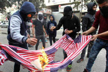 Burning of the American flag at a Palestinian "Day of Rage" protest in response to U.S. President Donald Trump's recognition of Jerusalem as Israel's capital, in the city of Hebron, December 22, 2017.