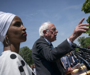 Democratic presidential candidate, Sen. Bernie Sanders, I-Vt., center, joined at left by Rep. Ilhan Omar, D-Minn.