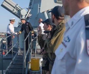 NATO and Israeli naval officials greet one another aboard an Israeli Navy ship.
