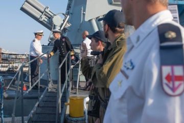 NATO and Israeli naval officials greet one another aboard an Israeli Navy ship.