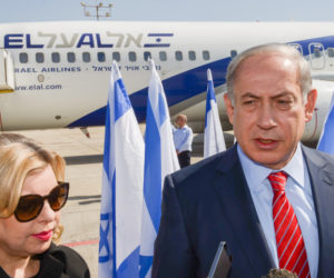 Israeli prime minister Benjamin Netanyahu addresses reporters with his wife Sara by his side.