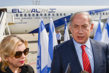 Israeli prime minister Benjamin Netanyahu addresses reporters with his wife Sara by his side.