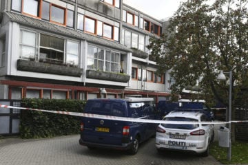 Police cars are parked outside an apartment building cordoned off in Copenhagen, Denmark, Sept. 21, 2017 after Danish authorities said a man and woman were arrested, suspected of a connection to Islamic State.