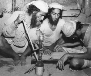In this March 3, 1949 file photo, three Jews are seen reading a copy of the Bible at a Jewish refugee camp at Hashid in the British Colony of Aden, Yemen.