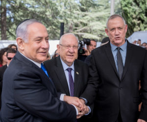 Blue and White leader MK Benny Gantz, right, shakes hands with President Reuven Rivlin, center, and Prime Minister Benjamin Netanyahu at a memorial ceremony for the late President Shimon Peres, at the Mount Herzl cemetery in Jerusalem, on September 19, 2019.