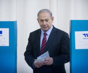 Israeli Prime Minister and head of the Likud party Benjamin Netanyahu casts his vote in the Likud primary elections on December 31, 2014.