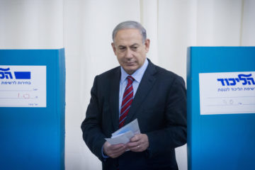 Israeli Prime Minister and head of the Likud party Benjamin Netanyahu casts his vote in the Likud primary elections on December 31, 2014.