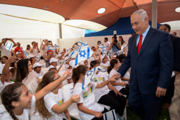 Prime Minister Benjamin Netanyahu greets children on the first day of school, September 1, 2017.