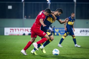 Umm al-Fahm player, in red, battling for ball against Tel Aviv opponent in State Cup competition, Afula, Israel, on Dec. 21, 2019.