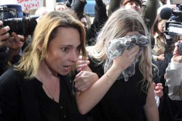 19-year old British woman covers her face as she arrives at a district court escorted by her mother, for sentencing after she was found guilty of inventing claims she was raped by up to 12 Israelis, in Paralimni, Cyprus, Tuesday, Jan. 7, 2020.