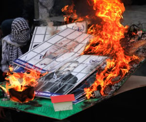 In Nablus, PA territory, Fatah supporters burn a model of an Israeli Jewish community and images of Israeli political leaders during a rally to celebrate the 55th anniversary of Fatah's first attack against Israel, January 6, 2020.