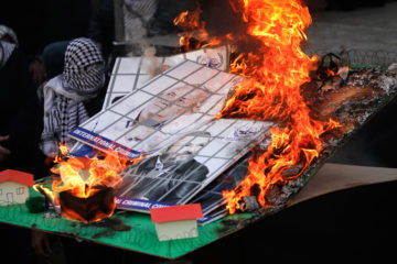 In Nablus, PA territory, Fatah supporters burn a model of an Israeli Jewish community and images of Israeli political leaders during a rally to celebrate the 55th anniversary of Fatah's first attack against Israel, January 6, 2020.