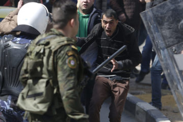 Palestinian policeman confronts a Hizb-ut-Tahrir party supporter during demonstration against political arrests of the party members by the Palestinian Authority in Hebron, Feb. 25, 2017.