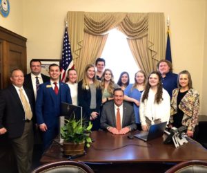 Rep. Russ Fulcher (R-Idaho) posing with staff in his congressional office.