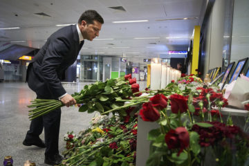 Ukrainian President Volodymyr Zelenskiy lays flowers at Borispil International Airport outside Kyiv, Ukraine, where a memorial was set up in the aftermath of the crash of a Ukrainian airliner in Iran.