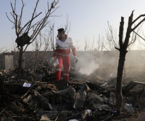 A rescue worker searches the scene where a Ukrainian plane crashed in Shahedshahr, southwest of the capital Tehran, Iran, Wednesday, Jan. 8, 2020.