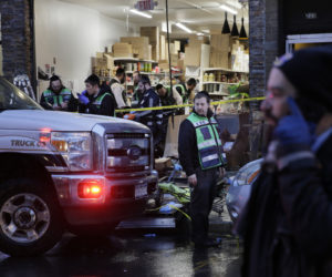 In this Dec. 11, 2019 photo, emergency responders work at a kosher supermarket, the site of a shooting in Jersey City, N.J.