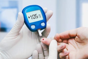 Doctor conducting a blood sugar test in a clinic for diabetes.