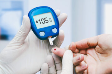 Doctor conducting a blood sugar test in a clinic for diabetes.