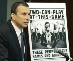 Raymond Duda, FBI Special Agent in Charge in Seattle, speaks as he stands next to a poster that was mailed earlier in the year to the home of Chris Ingalls, an investigative reporter with KING-TV in Seattle, Wednesday, Feb. 26, 2020, during a news conference in Seattle.
