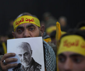 A Hezbollah supporter holds a portrait of slain Iranian Gen. Qassem Soleimani at a rally in a southern suburb of Beirut, Lebanon, Jan. 5, 2020 following the U.S. airstrike in Iraq that killed Soleimani.