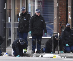 Police officers work at the scene of Sunday's terror stabbing attack in the Streatham area of south London on Monday, Feb. 3, 2020.