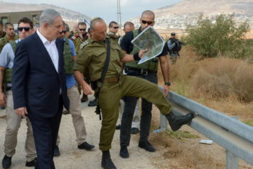 Israeli Prime Minister Benjamin Netanyahu (L) on a visit to Judea and Samaria